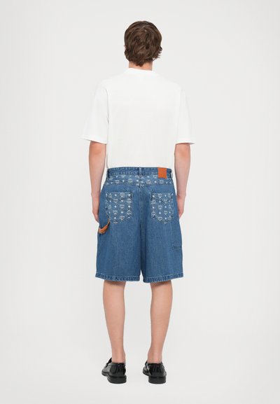 Denim shorts with a blue pattern and a brown leather patch on the waistband. Features two back pockets and a side pocket.