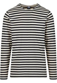 Långärmad randig skjorta i krämfärgad och svart. Tillverkad av bomull, har rund halsringning och horisontella ränder i varierande bredder.