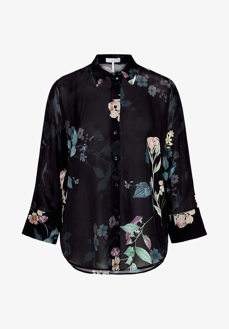 Blouse noire à manches longues boutonnée avec col pointu et imprimés floraux pastel en vert, rose, violet et blanc.
