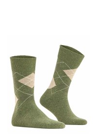 Calze verdi lavorate a maglia con un motivo a diamante in beige e bianco. Cuffia a coste, texture morbida e aree di tallone e punta rinforzate.