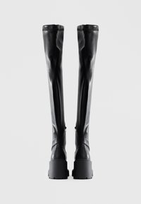 Black over-the-knee boots made from smooth leather, featuring a chunky platform sole and a fitted design with a subtle top stitching detail.
