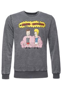 Sweat-shirt gris avec un graphique de deux personnages animés assis sur un canapé rose, contours noirs avec des accents jaunes en arrière-plan.
