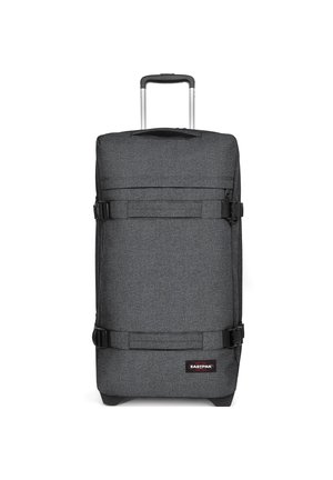 Gray fabric wheeled suitcase with a retractable handle, two buckled straps, and a rectangular shape; features a logo patch on the front.