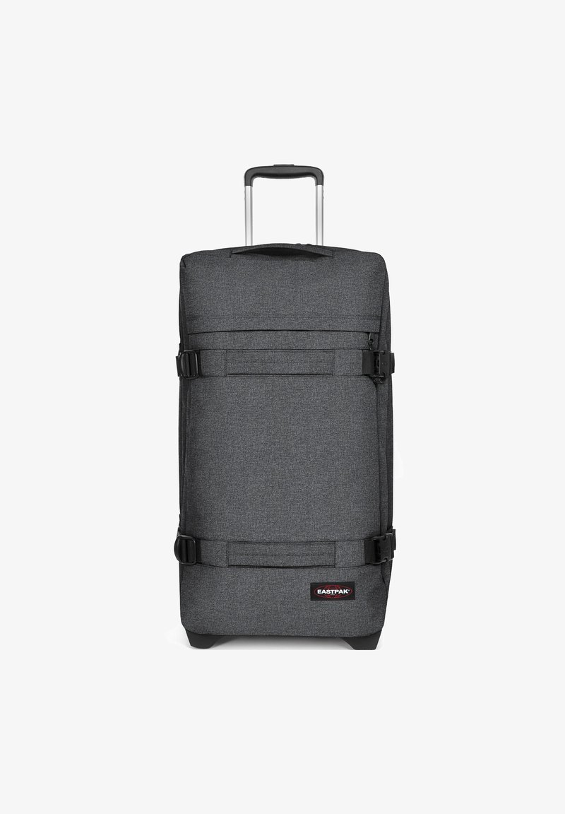 Gray fabric suitcase with a telescopic handle, featuring two adjustable straps and a logo patch at the bottom. Rectangular shape.