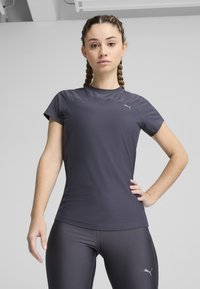 Tamsiai pilka sportinė marškinė su lengvu audiniu, trumpomis rankovėmis ir apvaliu iškirpimu, puikuojasi subtiliu siuvinėjimu ir mažu logotipo detaliu.
