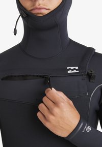 Black wetsuit with a high collar, features a front zip pocket, water-resistant zipper, and textured arm cuffs. Logo on shoulder area.