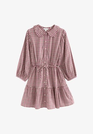 Sukienka w kratę z okrągłym kołnierzykiem, długimi rękawami i sznurkiem w talii. Posiada warstwową spódnicę w fioletowo-białą kratę.