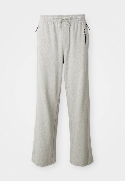 Gray sweatpants made of soft fabric, featuring a drawstring waist, side pockets, and a printed logo along the left leg.