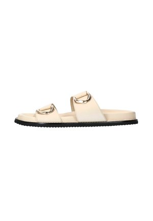 Beige slide sandals with two wide straps featuring circular metallic accents, constructed from smooth synthetic material, and a black textured sole.
