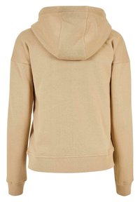 Beige hettegenser med teksturert stoff, ribbestrikkede mansjetter og kant. Hette er avslappet med et enkelt design, passende for uformell bruk.