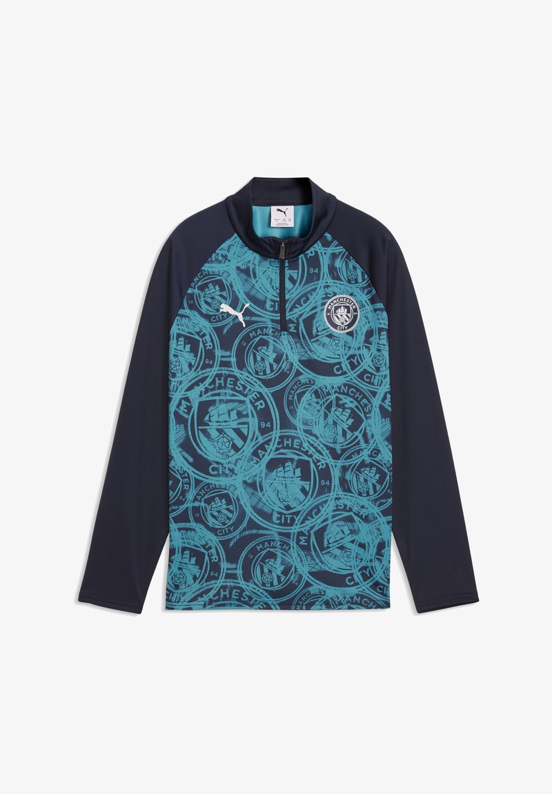Maglia sportiva a maniche lunghe di colore blu navy e turchese del Manchester City con stampa di tutti i crest del club e collo con zip a quarto.