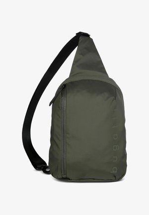 Olive green sling backpack with black adjustable strap and vertical zipper pocket on front, showing subtle "bugatti" branding on side.