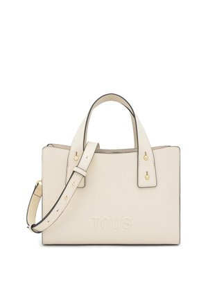 Borsa rettangolare color crema con doppio manico superiore, tracolla removibile e logo "TOUS" impresso sul davanti.