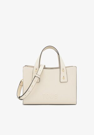 Borsa rettangolare color crema con doppio manico superiore, tracolla removibile e logo "TOUS" impresso sul davanti.