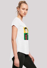 White, short-sleeve T-shirt with a relaxed fit, featuring a colorful graphic of two illustrated faces. Soft fabric with a slightly curved hem.