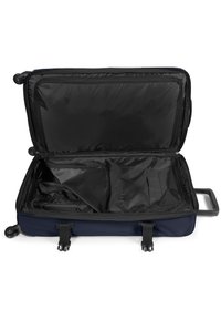 Valigia da viaggio blu navy con interni neri aperti. Le caratteristiche includono cinghie regolabili, tasche interne e una maniglia robusta.