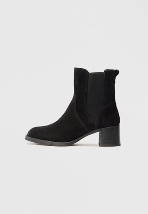 Black suede ankle boots with a round toe, elastic side panels, and a textured block heel. Smooth finish with subtle stitching details.