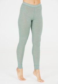 Lichte groene leggings gemaakt van zachte, gestructureerde stof met een aansluitend ontwerp. Beschikt over een brede tailleband en taps toelopende broekspijpen.