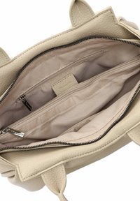 Light beige leather handbag with a textured surface, featuring a zippered closure and three inner pockets, including one zippered compartment.