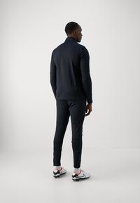 Under Armour CHALLENGER - Treniņtērpa apakšdaļas - black/high vis yellow