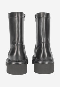 Black leather ankle boots with a smooth finish, round toe, zipper closure, and thick textured soles. Stitched detailing along the edges.
