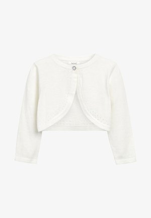 Biały, krótki bolerowy kardigan z długim rękawem, zapinany na pojedynczy dekoracyjny guzik, z subtelnymi oczkowymi detalami na krawędziach.