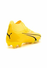 Gelbe Fußballschuhe mit einer strukturierten Synthetik-Oberfläche, schwarzen Akzenten und einem niedrig geschnittenen Design. Verfügt über transparente Stollen für besseren Halt.