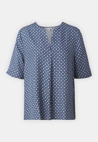 Blusa blu navy con maniche corte, scollo a V e motivo geometriche a diamante bianche con piccoli dettagli rossi. Tessuto morbido, vestibilità rilassata.