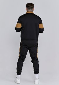 SIKSILK MUSCLE FIT JOGGERS - Tracksuit bottoms - black