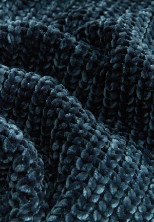 Soft, plush teal velvet fabric with a thick, textured surface and rounded, tufted pattern, creating a rich tactile appearance.