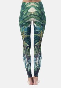 Leggings gemaakt van rekbare stof met een groen tropisch bladerenpatroon, met een hoge taille en een aansluitende stijl. Geweven oppervlakte details zichtbaar.