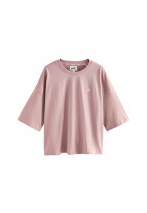 Roze katoenen t-shirt met een losse pasvorm, verlaagde schouders en korte mouwen. Heeft een klein "self." logo op de borst. Soepele textuur.
