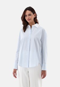 Light blue striped shirt made of cotton, featuring a classic collar, button front, and long sleeves with cuffs. Soft texture, relaxed fit.