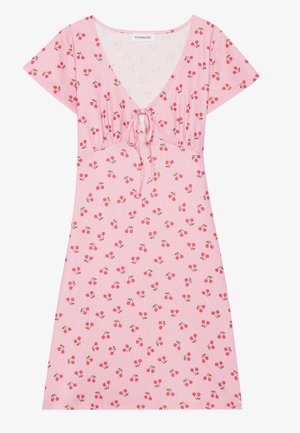 Pink dress featuring short sleeves, a deep V-neckline, adjustable tie front, and all-over cherry print on a textured fabric.