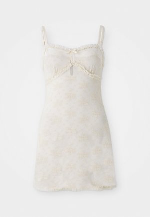 Nuisette sans manches ornée de dentelle, en crème clair avec broderies florales, présentant un détail en forme de clé à la poitrine et un ourlet évasé.