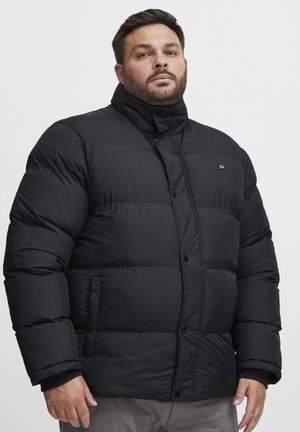 Black padded coat with a high collar, snap-button closure, and side pockets. Features quilted texture and a logo on the chest.