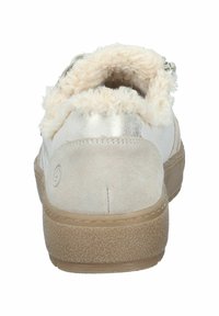 Zapato de color claro con cuerpo de ante, suave cuello de piel sintética, detalles metálicos en la parte posterior y suela de goma texturizada.