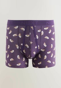 Violettiset bokserit, joissa on pieniä beigen ja valkoisen sävyisiä pöllökuvioita, ja vyötäröllä kohopainetut kirjaimet "NEXT".