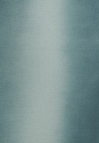 Tissu bleu clair texturé présentant un motif côtelé avec des variations subtiles de teinte. Surface lisse avec un léger éclat.