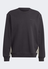 Svart sweatshirt med rund halsringning och långa ärmar. Har vita ränder längs sidorna och en subtil logo på bröstet. Mjuk textur.