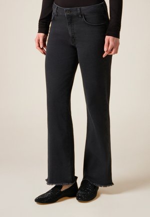 FLARE NERI CON ORLO SFRANGIATO - Flared jeans - nero