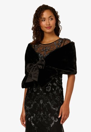 Black faux fur wrap with a large satin bow, featuring a soft texture and elegant design, complementing a beaded black dress.