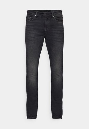 Jeans in denim nero con una vestibilità slim, cinque tasche e chiusura a bottone. Leggera scoloritura e dettagli di cucitura lungo le cuciture.
