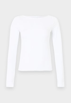 Λευκό πουκάμισο με μακριά μανίκια, κατασκευασμένο από λείο μείγμα βαμβακιού. Διαθέτει λαιμόκοψη σκάφος και εφαρμοστή σιλουέτα. Απλός σχεδιασμός, χωρίς ορατά μοτίβα ή διακοσμήσεις.