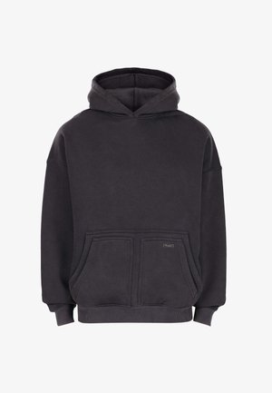 Black oversized hoodie with front kangaroo pocket, ribbed cuffs and hem, and a small rectangular logo tag on the pocket.
