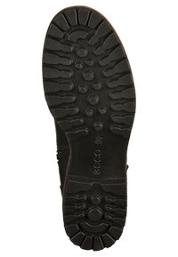 Semelle de chaussure en caoutchouc noir avec un motif de bande de roulement texturé comprenant des accents circulaires et rainurés pour une meilleure adhérence et durabilité.