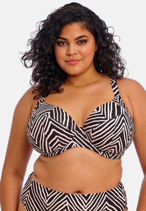Bikini de rayas en blanco y negro con un patrón de zigzag, que cuenta con copas con aro, tirantes anchos y una textura suave y ajustada.