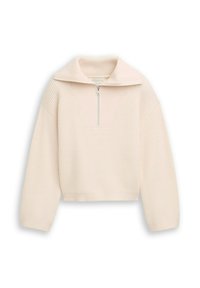 Helles beige, kurz geschnittenes Oberteil mit Rippenstruktur, halbseitigem Reißverschluss und breitem Kragen. Lange Ärmel und ein strukturiertes Design. Auffällige V-förmige Naht.