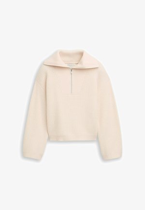 Light beige cropped pullover with a ribbed texture, half-zip closure, and wide collar. Long sleeves and a structured design. Notable V-shaped seam.
