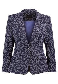 Námořnický blejzr s bílým abstraktním vzorem, na míru střižený, s klopovým límcem, dvěma předními kapsami a jedním knoflíkem na zapínání. Lehká tkanina.